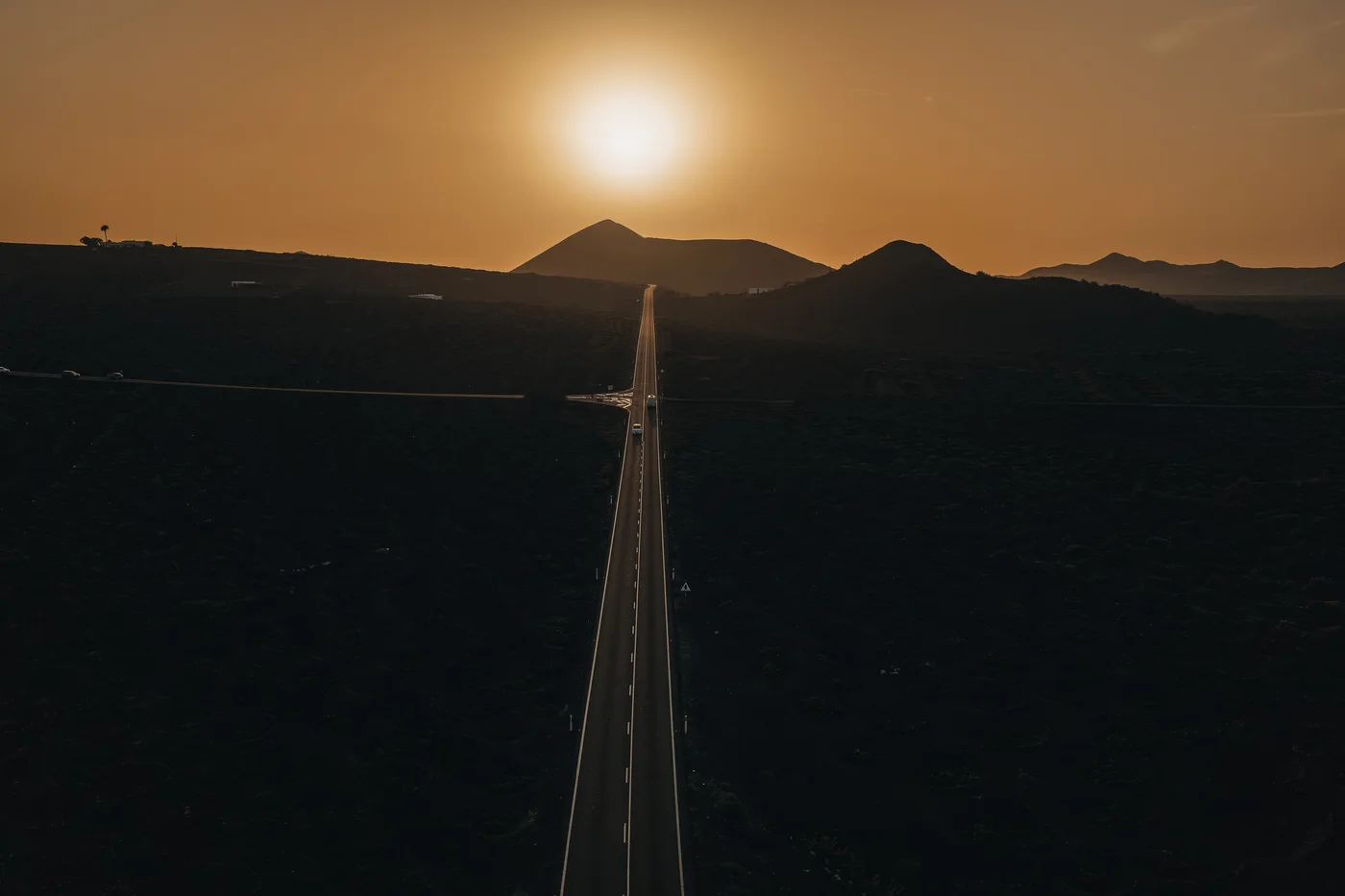 A road through Lanzarote’s volcanic landscape at sunset